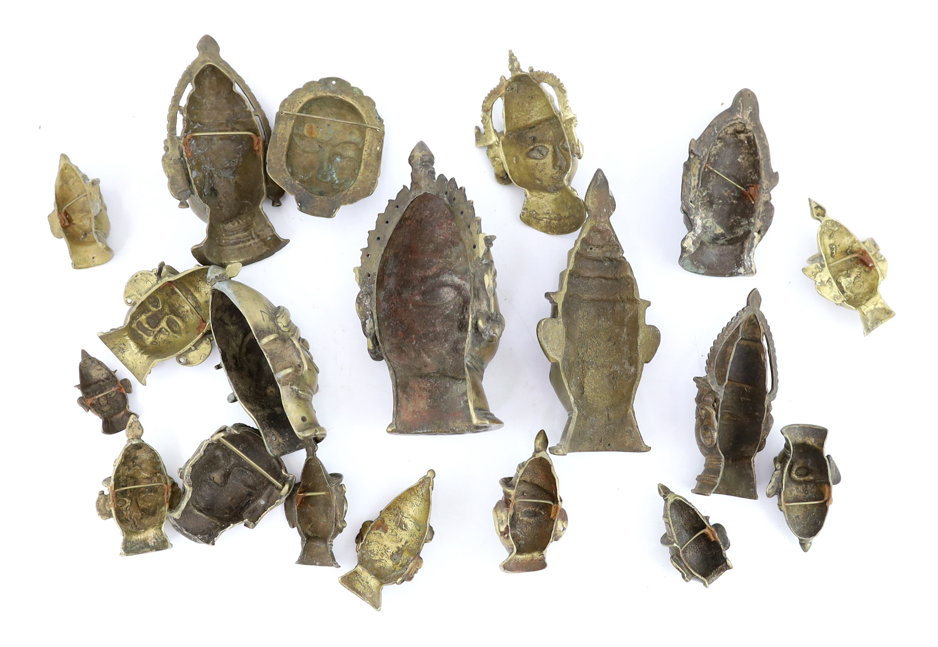 A group of nineteen bronze or brass Shiva masks, Southern India, 16th-19th century, 6.2 - 19.5cm high